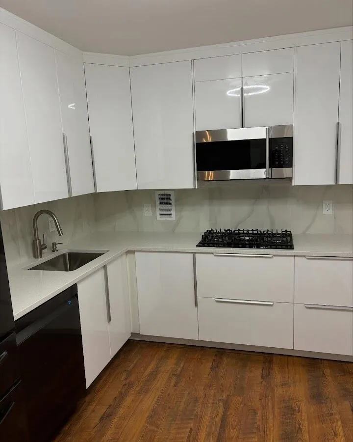 Restored kitchen with white cabinets after water damage in El Granada